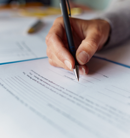 Signing a document. 